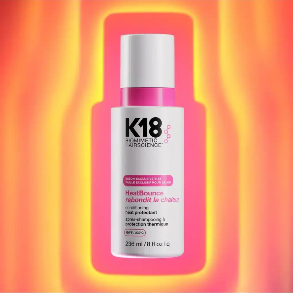 K18 HeatBounce protecteur thermique cheveux 236ml, protège jusqu'à 232°C, flacon blanc sur fond dégradé rose.